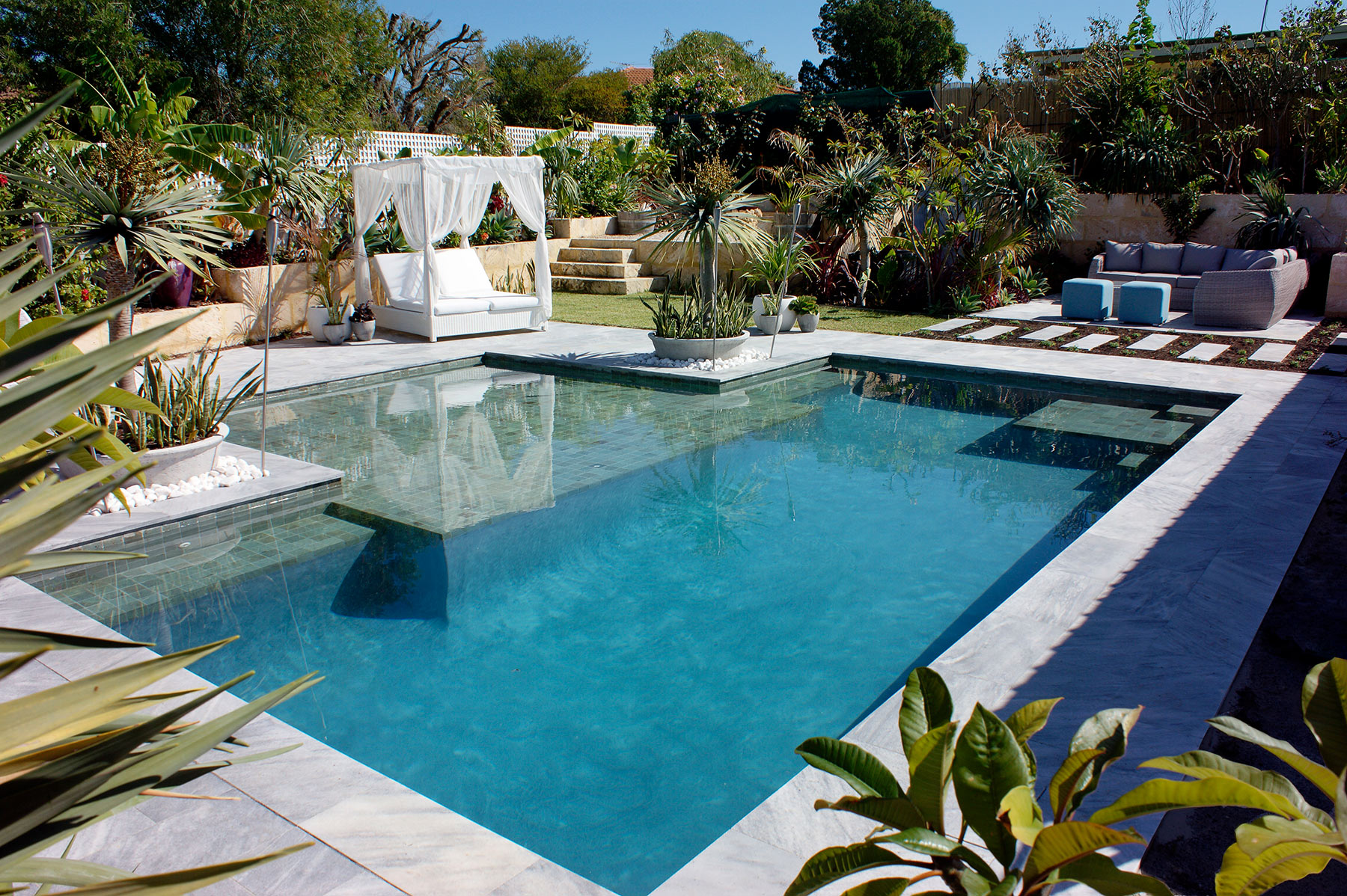 A premium pool with a cabana and lounge area