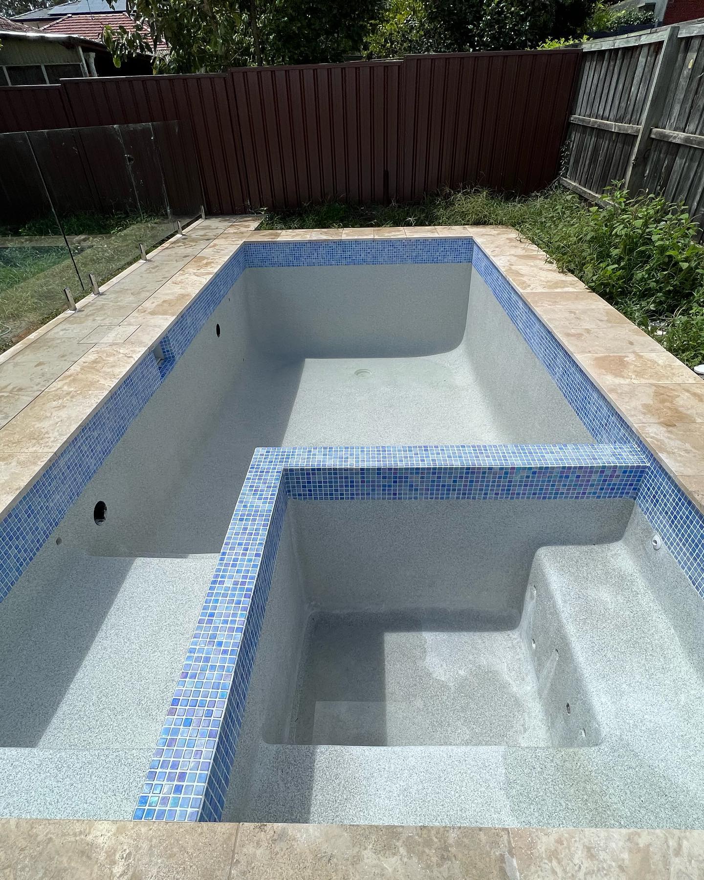 A recently completed concrete pool by The Pool Builders