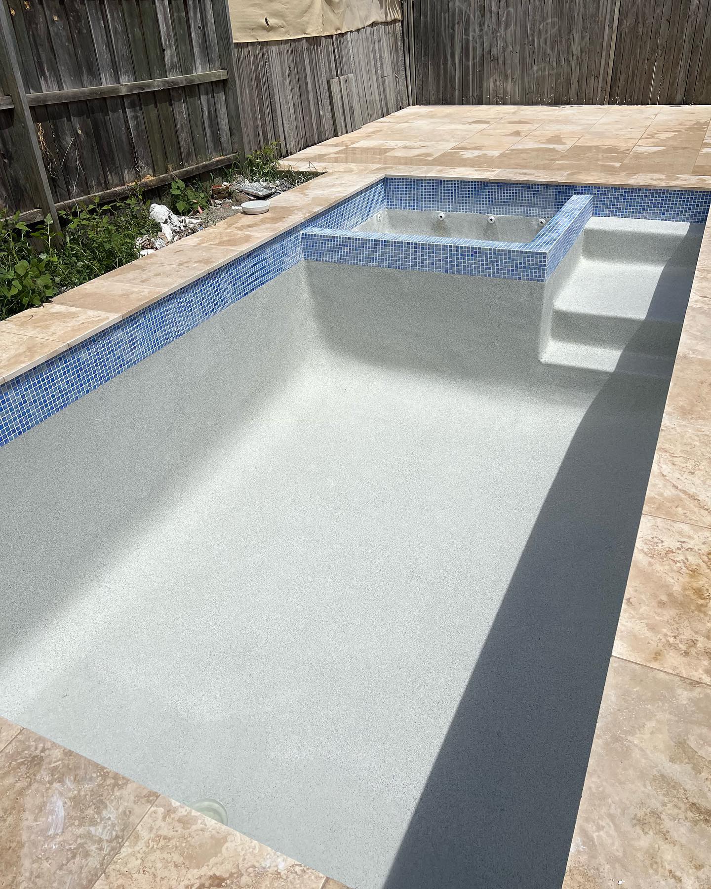 A recently completed concrete pool by The Pool Builders
