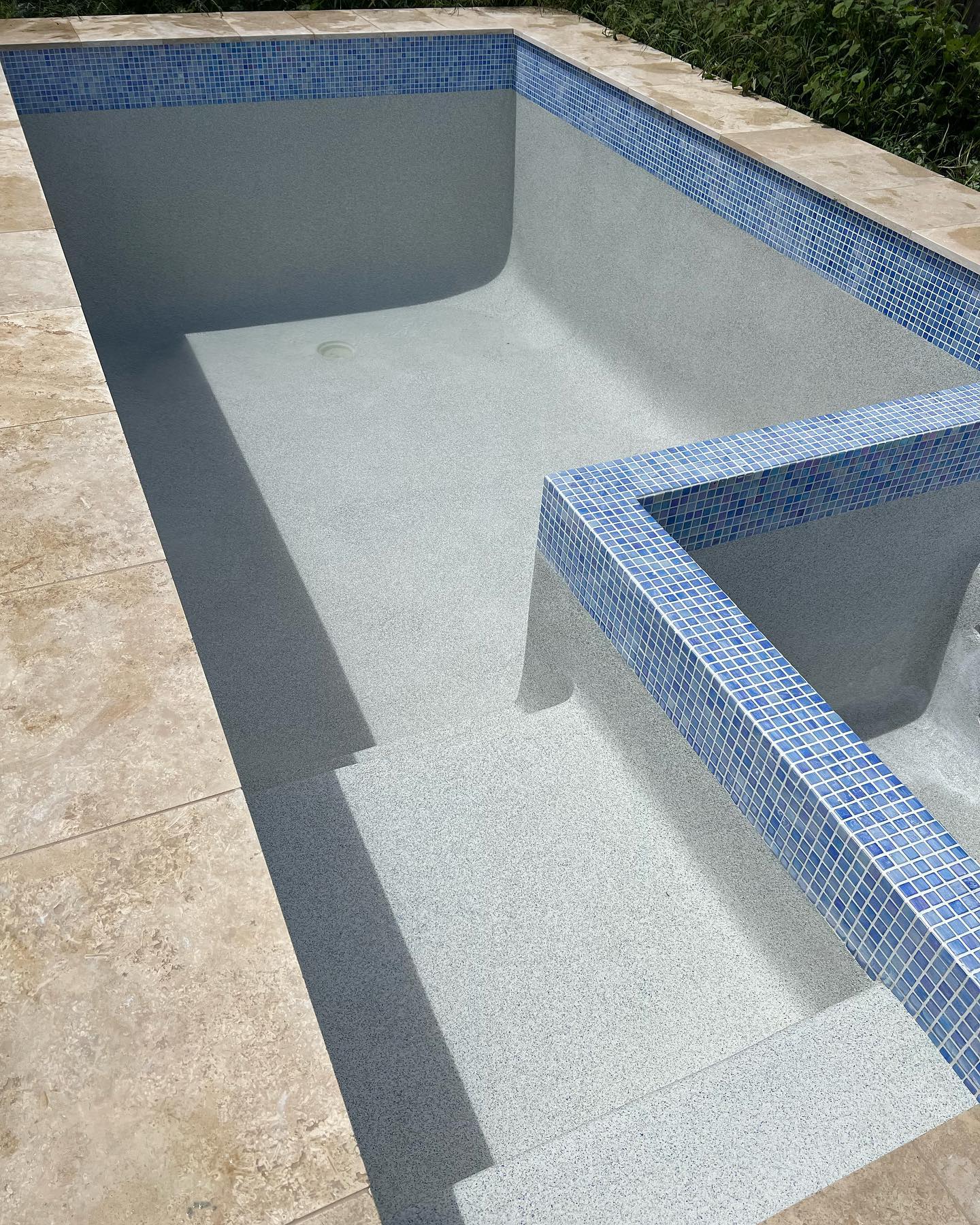 A recently completed concrete pool by The Pool Builders