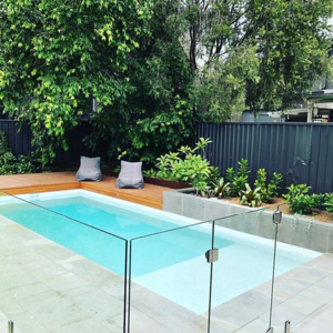 A pool finished in a Snow White interior with a timber deck