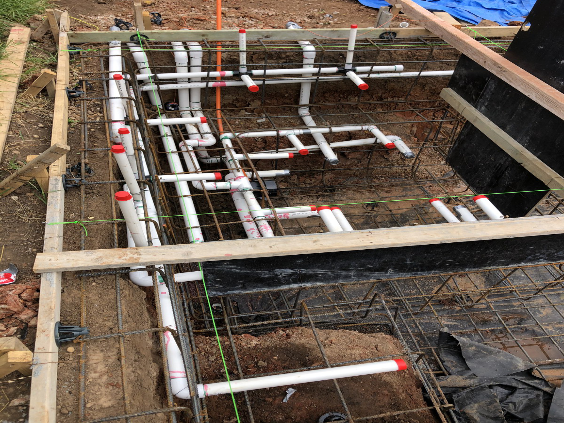 Pool plumbing lines and fittings being installed