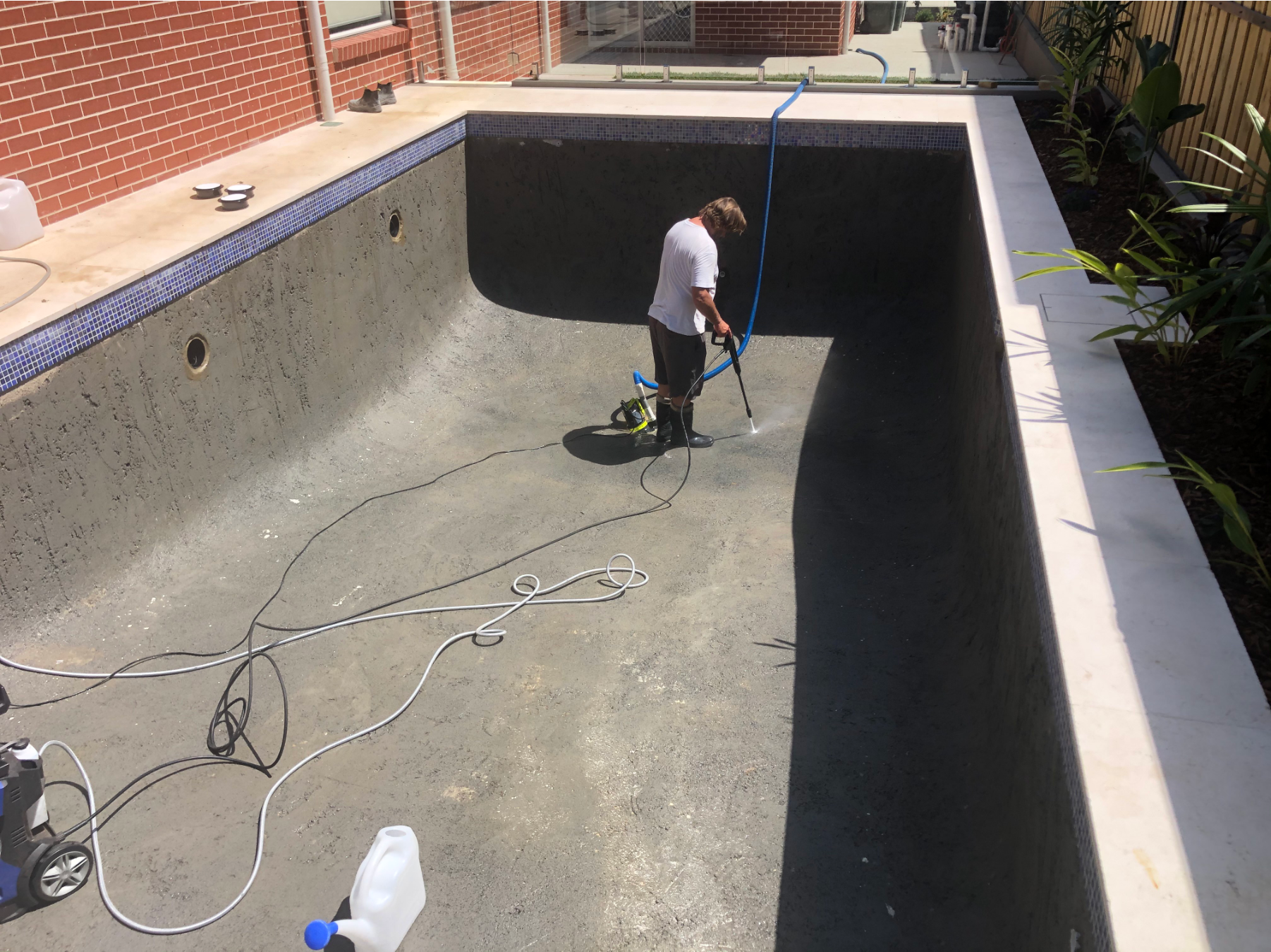 A cured concrete pool shell being prepped before the interior finish