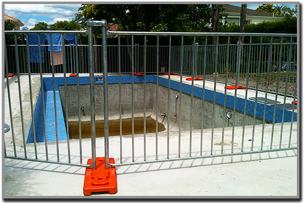 Frameless glass safety fencing installed around a new pool