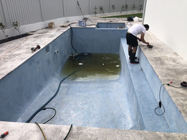 Cleaning and acid washing a new pool interior before filling